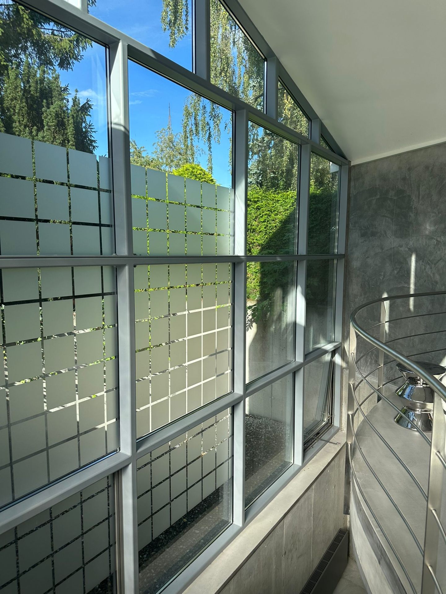 Glas en staal raampartij met uitzicht op groen